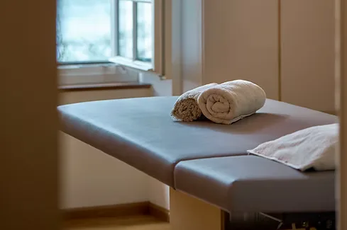 Man relaxing in doorway with natural light, embodying calm presence and self-awareness central to body-centered healing.